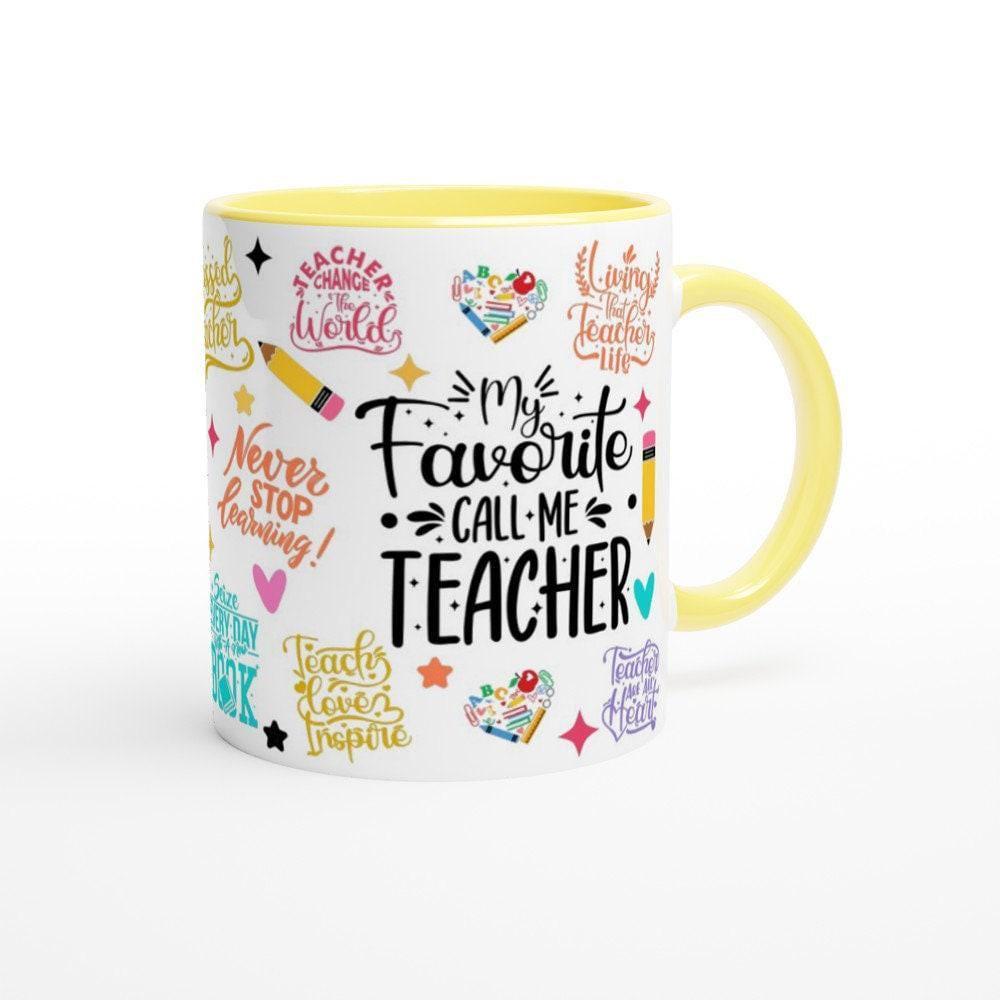 Ceramic teacher mug styled on a wooden desk next to books and a pencil