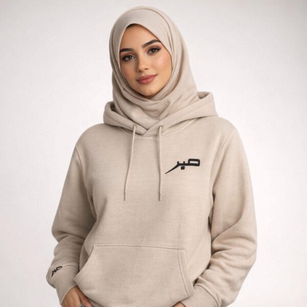 Flat lay of embroidered Sabr hoodie showing full garment and stitch quality