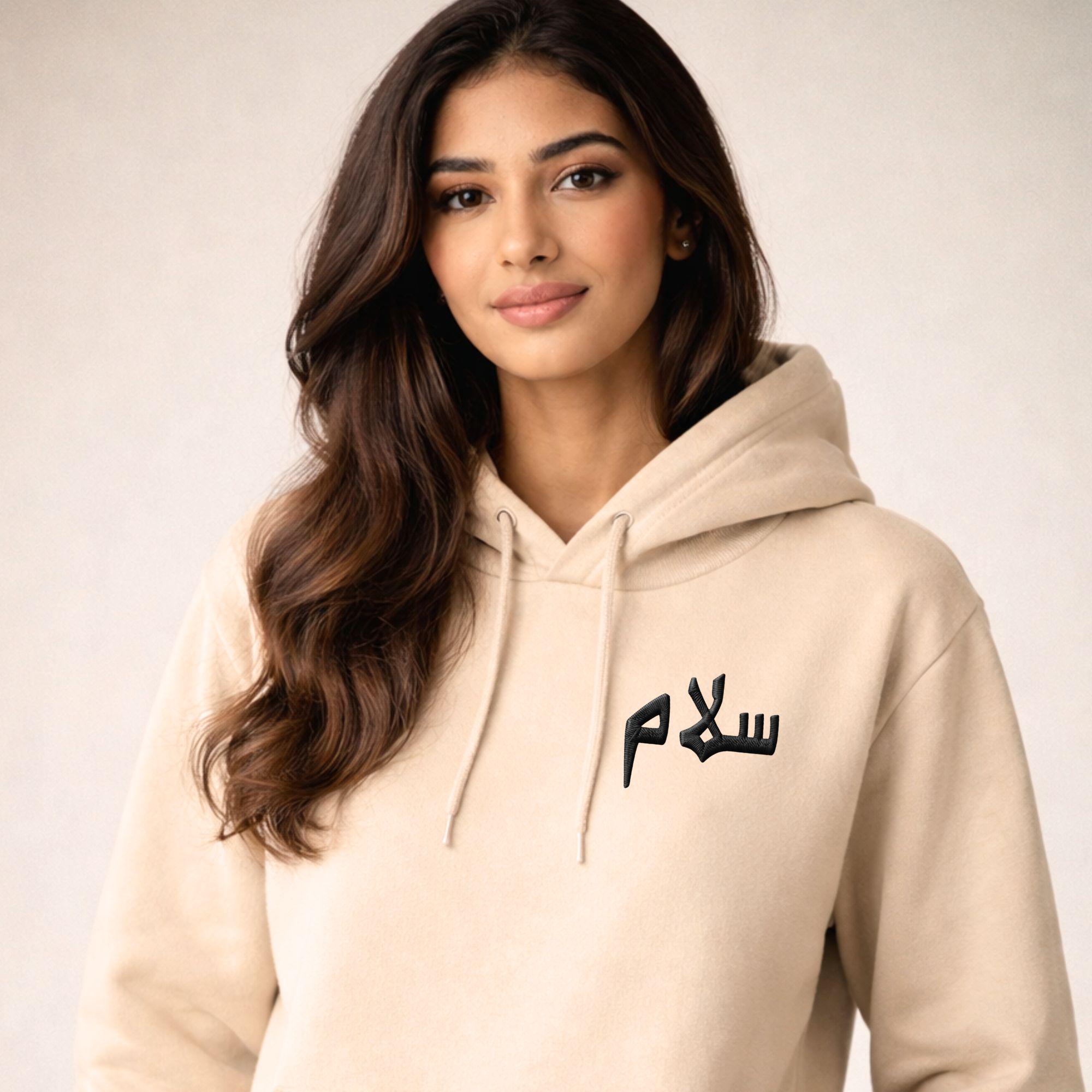 Person wearing Artkins salam embroidered hoodie, styled casually in everyday streetwear