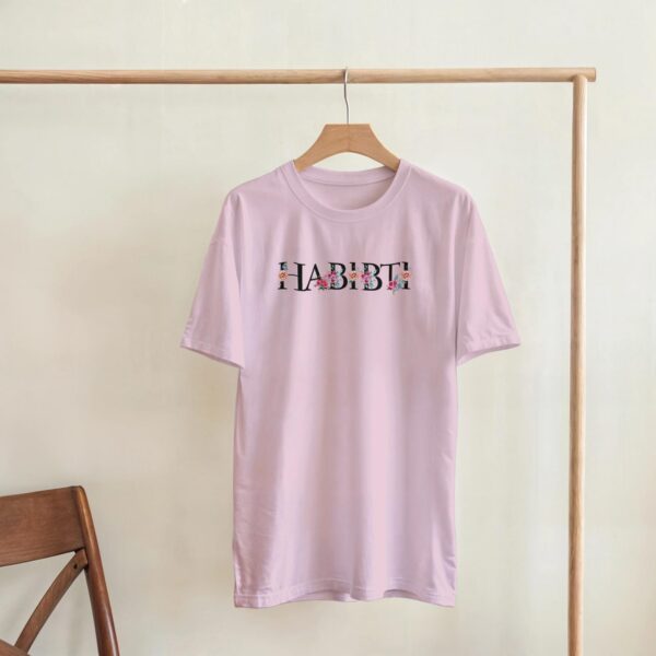 Close-up of floral Arabic script spelling Habibti on a women's t-shirt