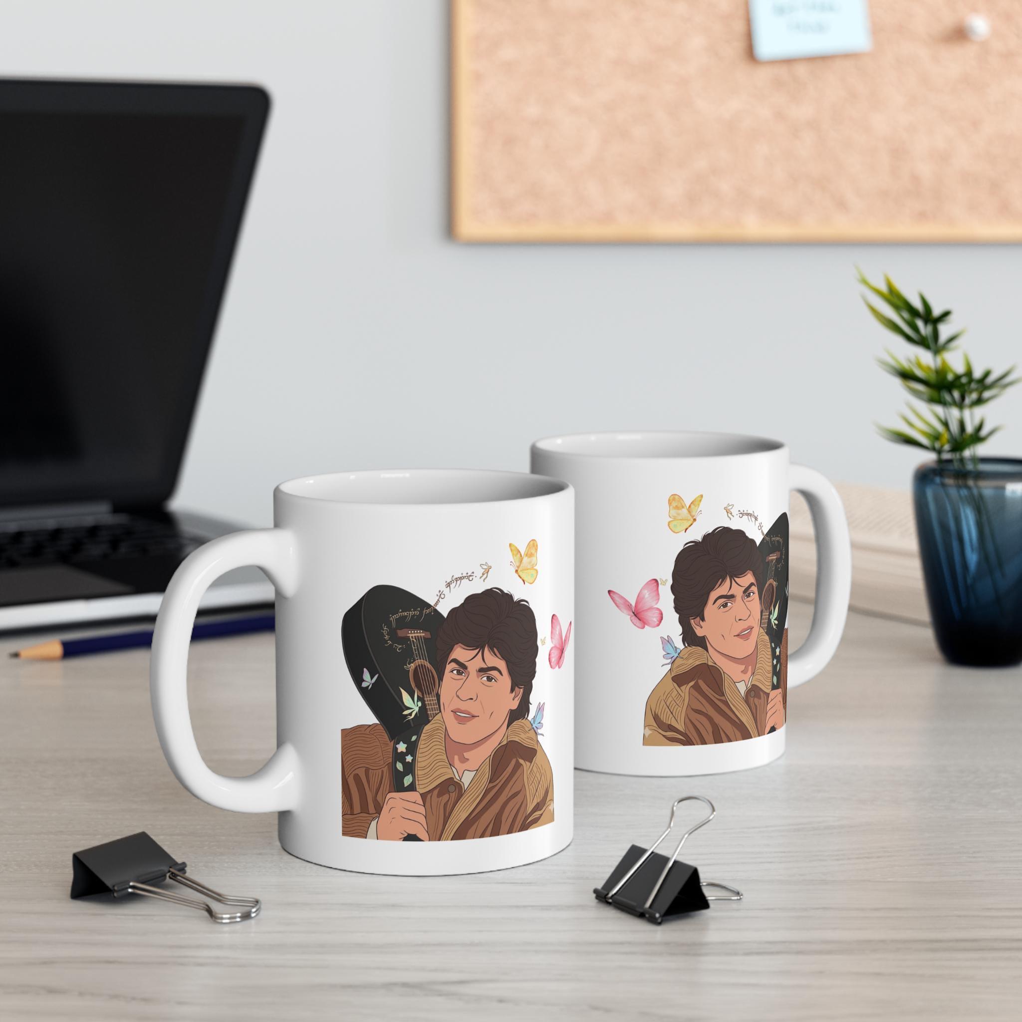 Close-up of DDLJ fan art mug showing guitar illustration and butterfly details