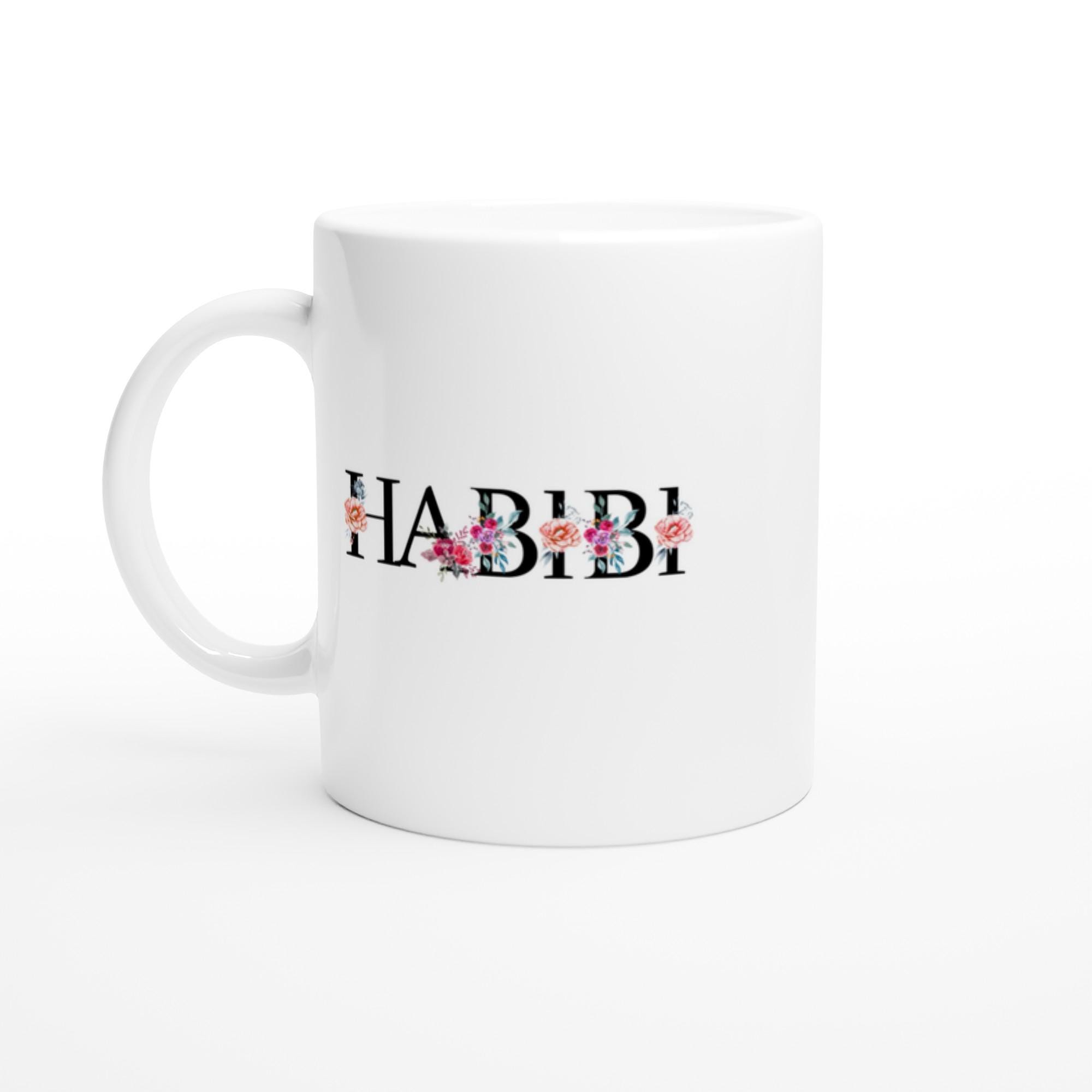 Close-up of Arabic habibi calligraphy and floral detail on glossy white ceramic mug