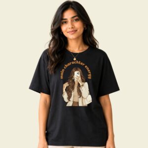 Desi girl graphic tee front view showing 'main character energy' lettering and retro illustration