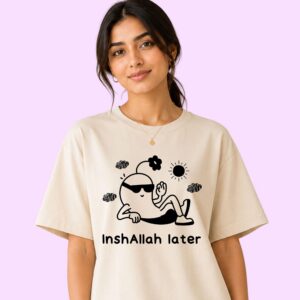Close-up of Inshallah Later graphic tee showing bold Arabic-inspired text and cartoon illustration